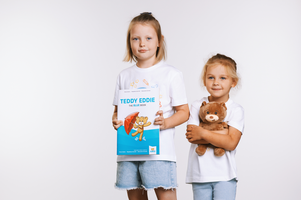 Kids with blue book and Teddy Eddie